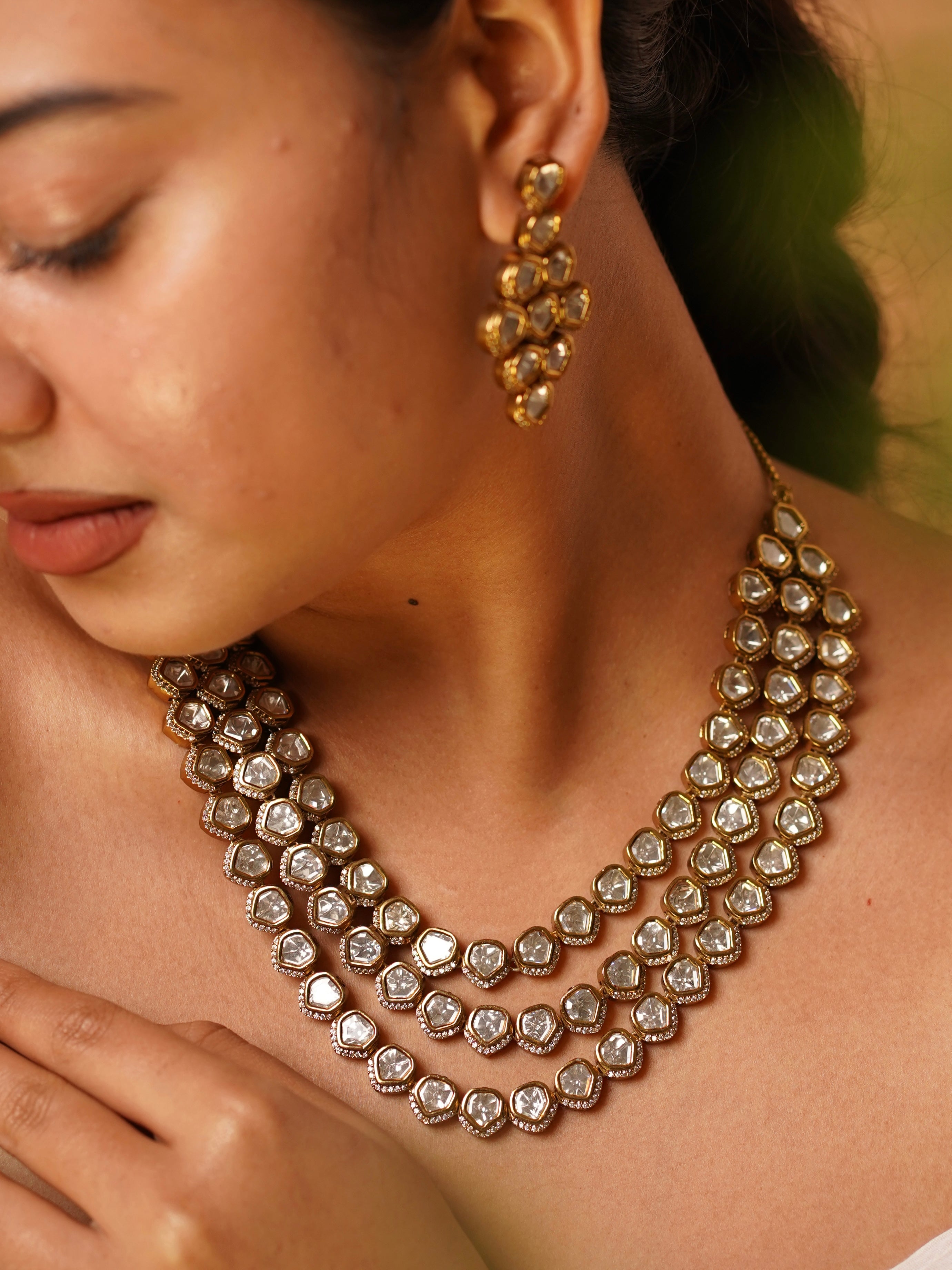 Full view of three-tier kundan necklace set with layered design and coordinating earrings